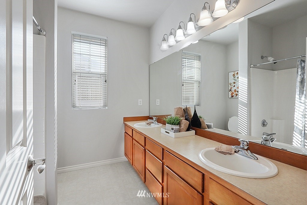 27714 Maple Ridge Way Southeast Maple Valley, WA 98038 - Photo 37 of 38 a bathroom with sinks granite countertop double vanity and a mirror
