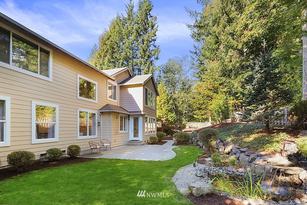 27714 Maple Ridge Way Southeast Maple Valley, WA 98038 - Photo 6 of 38 a front view of a house with a yard