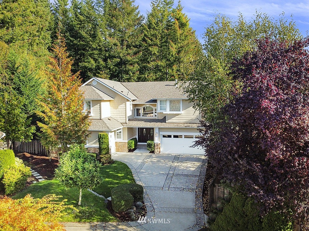 27714 Maple Ridge Way Southeast Maple Valley, WA 98038 - Photo 7 of 38 a view of a white house next to a yard with plants and trees