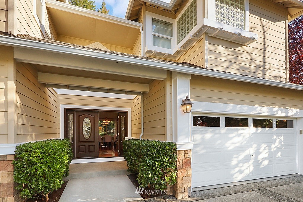 27714 Maple Ridge Way Southeast Maple Valley, WA 98038 - Photo 8 of 38 a front view of a house with garden