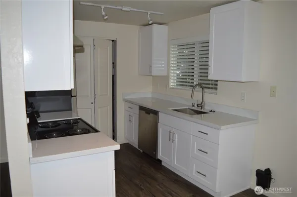 a kitchen with a sink and a stove top oven