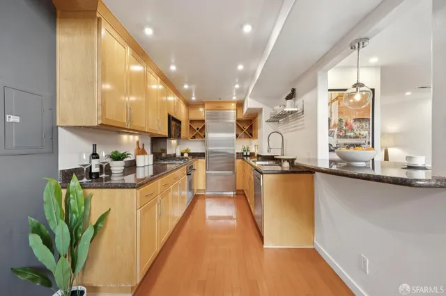 a kitchen with counter top space a sink appliances and cabinets
