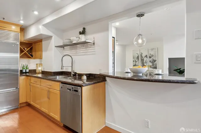 a kitchen with stainless steel appliances granite countertop a sink and cabinets