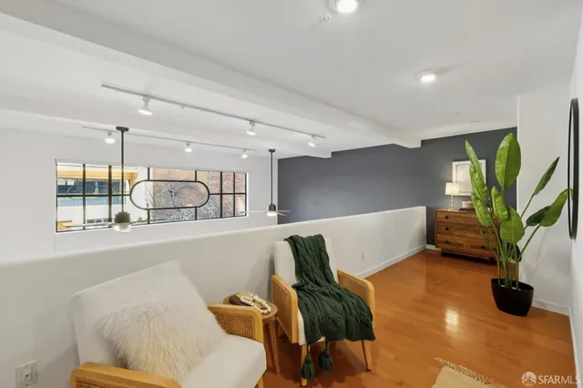 a living room with furniture and a potted plant