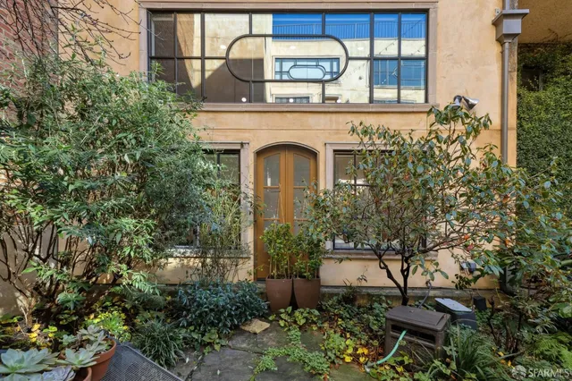 a view of a house with a small yard and plants