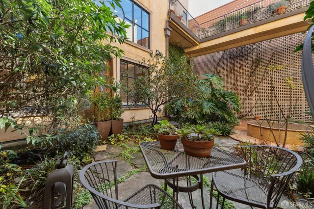 a view of a chairs and table in the patio