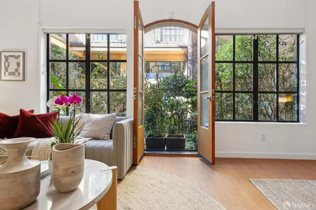 a living room with furniture and a potted plant