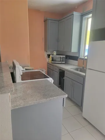 a kitchen with a sink stove and refrigerator