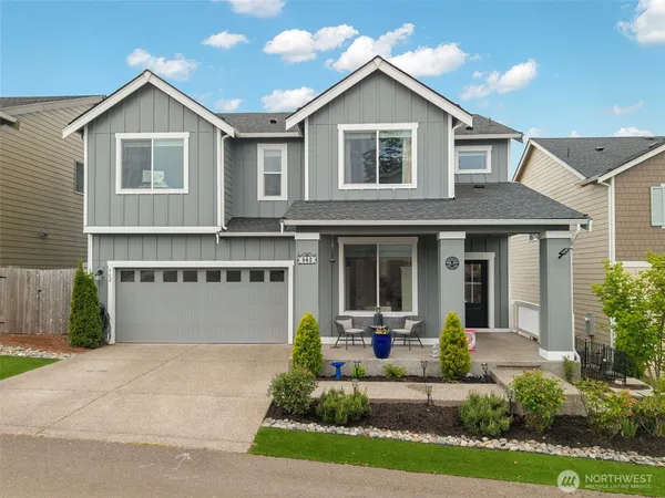 a front view of a house with a yard and garage