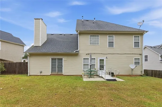 a backyard of a house with barbeque oven