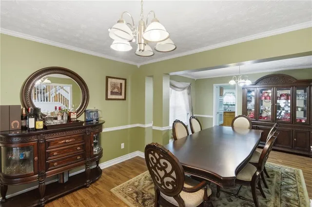 a dining room with furniture and chandelier
