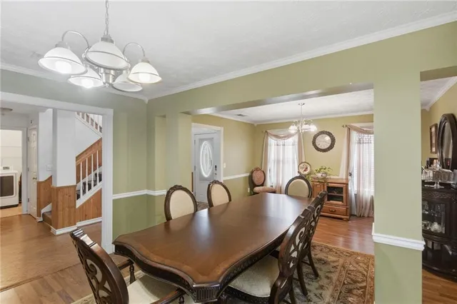 a view of a dining room with furniture and wooden floor