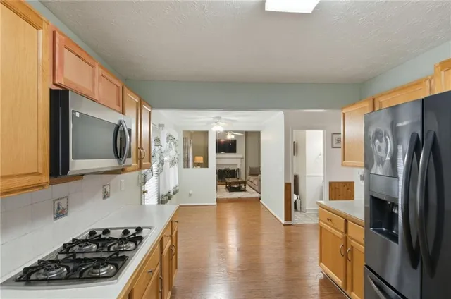 a kitchen with stainless steel appliances a stove a sink and a refrigerator