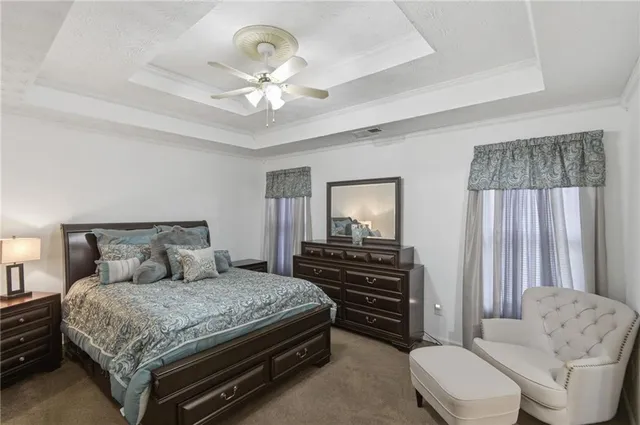 a bedroom with a bed and ceiling fan