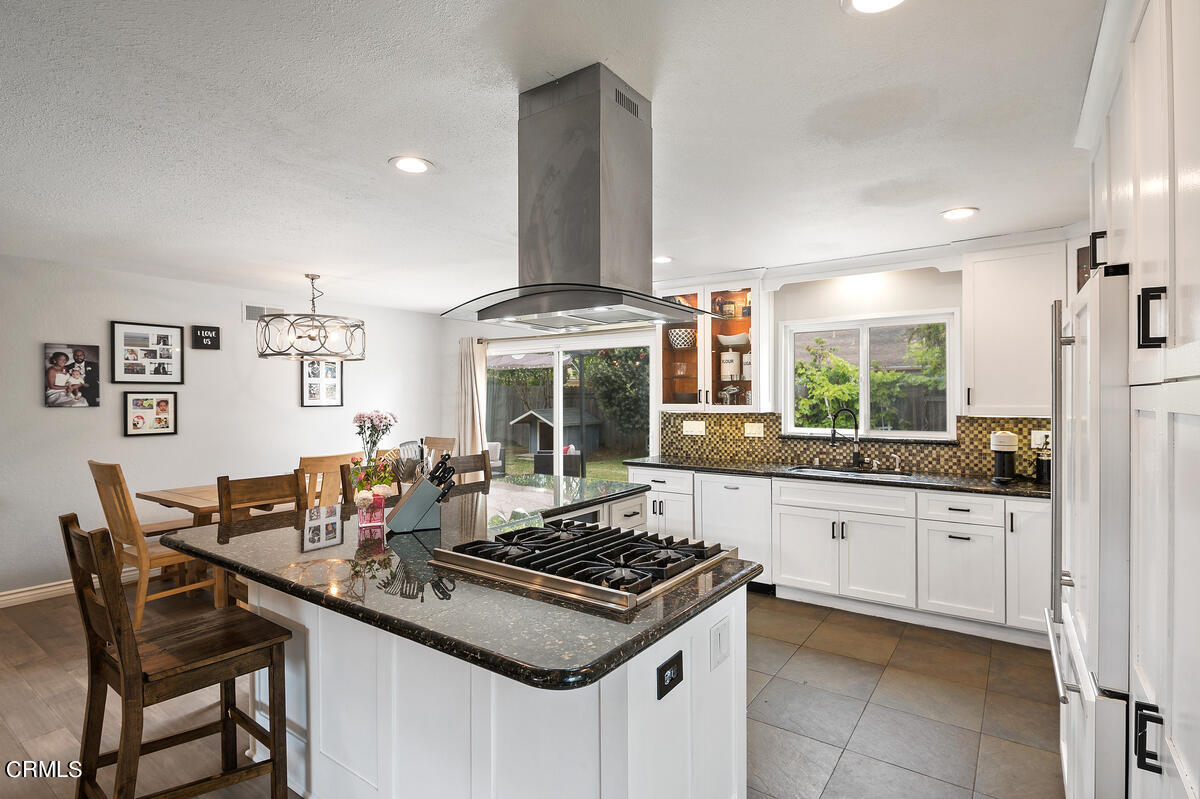 1540 Port Drive Oxnard, CA 93035 - Photo 15 of 39 a kitchen with granite countertop a sink stove and cabinets