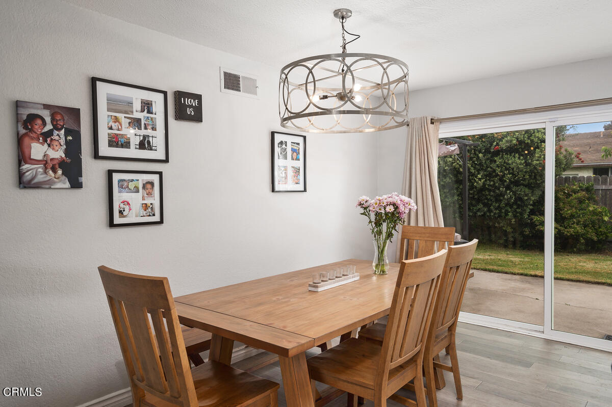 1540 Port Drive Oxnard, CA 93035 - Photo 19 of 39 a view of a dining room with furniture wooden floor and chandelier