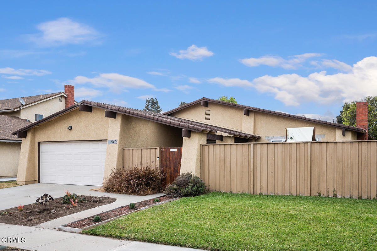 1540 Port Drive Oxnard, CA 93035 - Photo 3 of 39 a front view of a house with a yard
