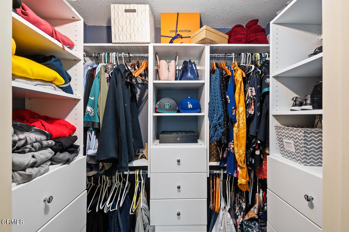 1540 Port Drive Oxnard, CA 93035 - Photo 25 of 39 a view of walk in closet with clothes and shoes
