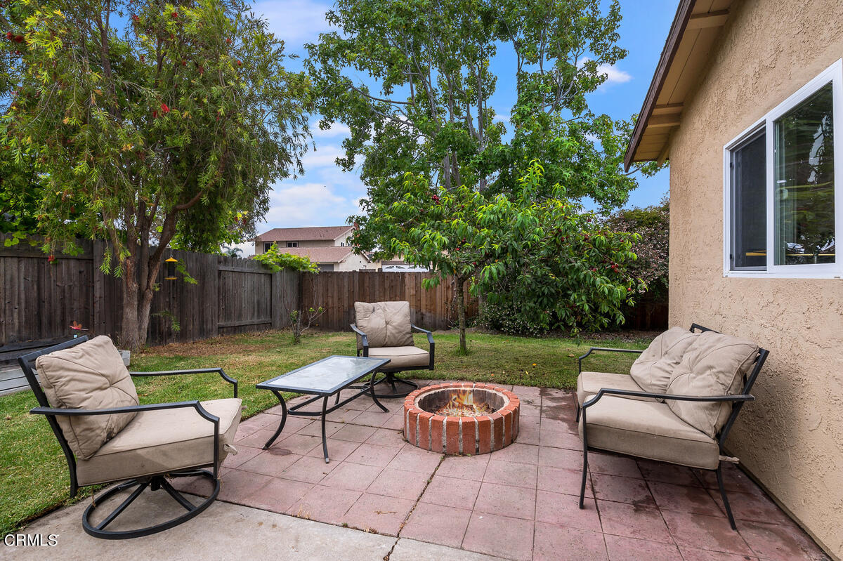 1540 Port Drive Oxnard, CA 93035 - Photo 32 of 39 a view of patio with couches and a table and chairs with wooden fence and plants