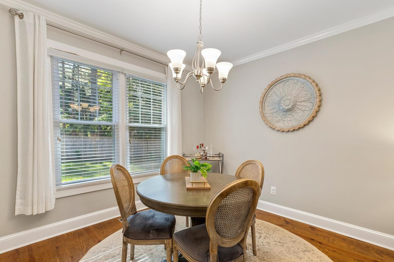 6600 Vancouver Lane Raleigh, NC 27615 - Photo 11 of 53 a dining room with furniture a potted plant and a chandelier