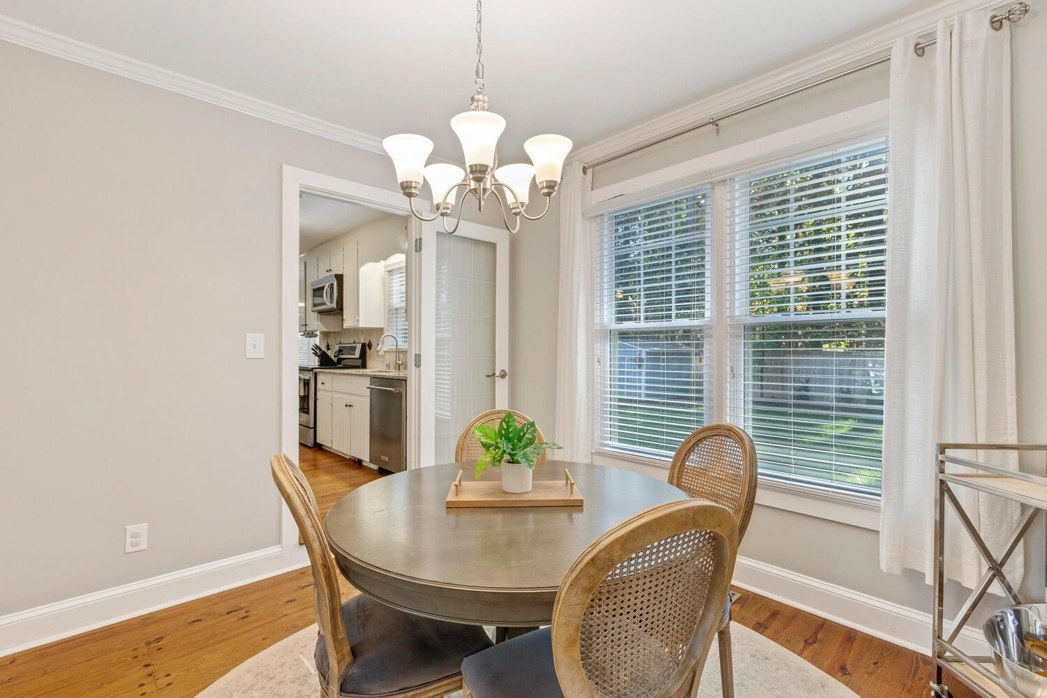 6600 Vancouver Lane Raleigh, NC 27615 - Photo 12 of 53 a view of a dining room with furniture window and wooden floor