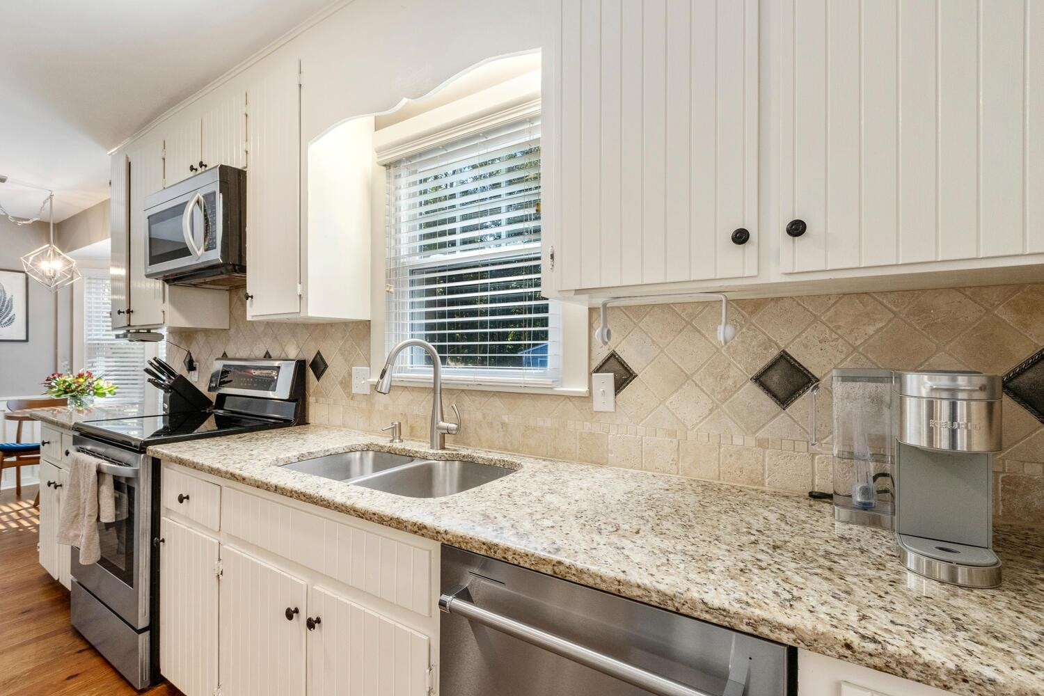 6600 Vancouver Lane Raleigh, NC 27615 - Photo 14 of 53 a kitchen with stainless steel appliances granite countertop a sink stove and cabinets
