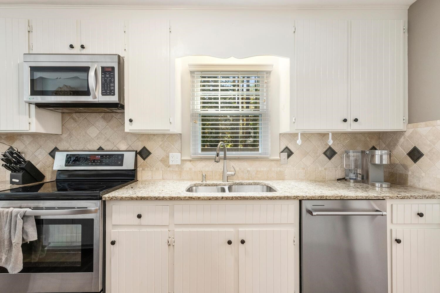 6600 Vancouver Lane Raleigh, NC 27615 - Photo 15 of 53 a kitchen with stainless steel appliances granite countertop a sink a stove a microwave and cabinets