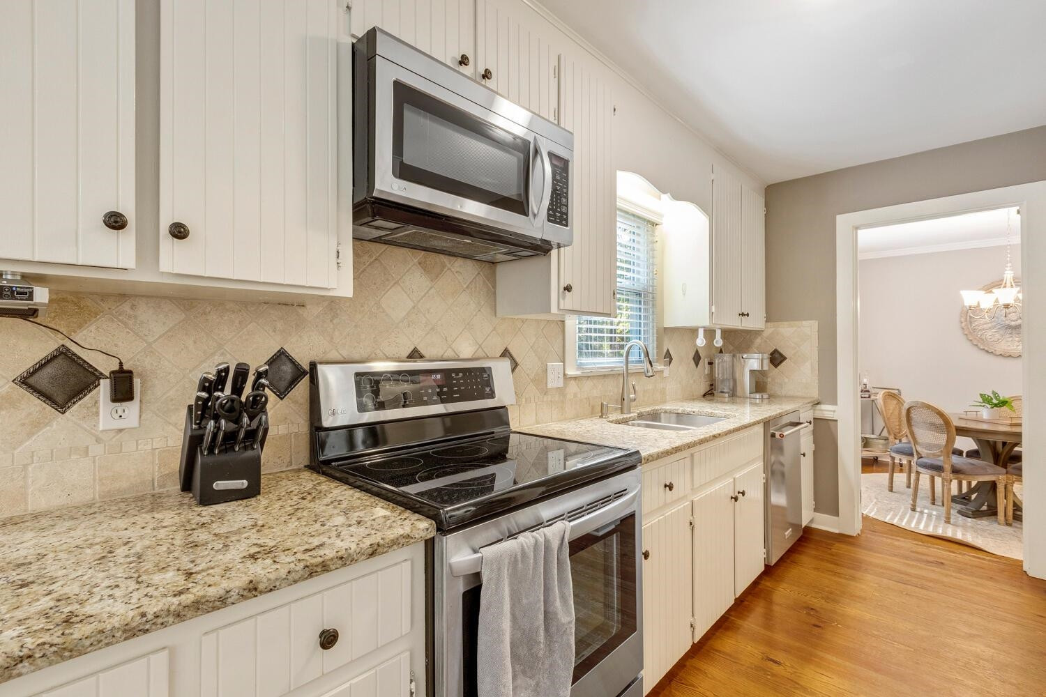 6600 Vancouver Lane Raleigh, NC 27615 - Photo 16 of 53 a kitchen with stainless steel appliances granite countertop a sink stove and microwave
