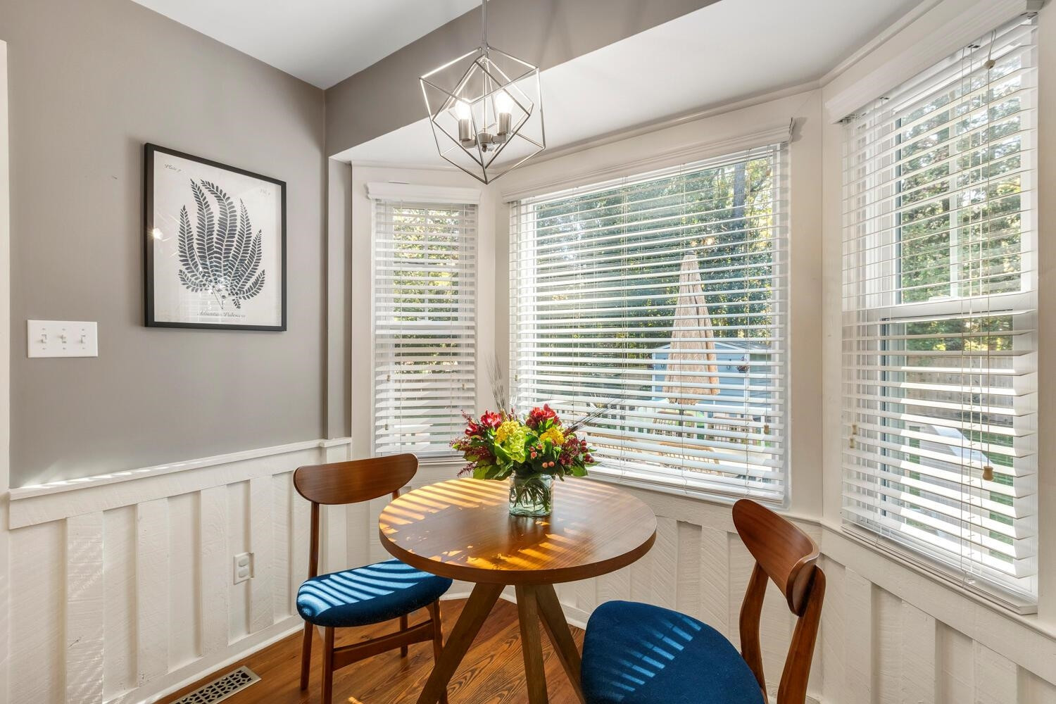 6600 Vancouver Lane Raleigh, NC 27615 - Photo 19 of 53 a view of a dining room with furniture wooden floor and a chandelier