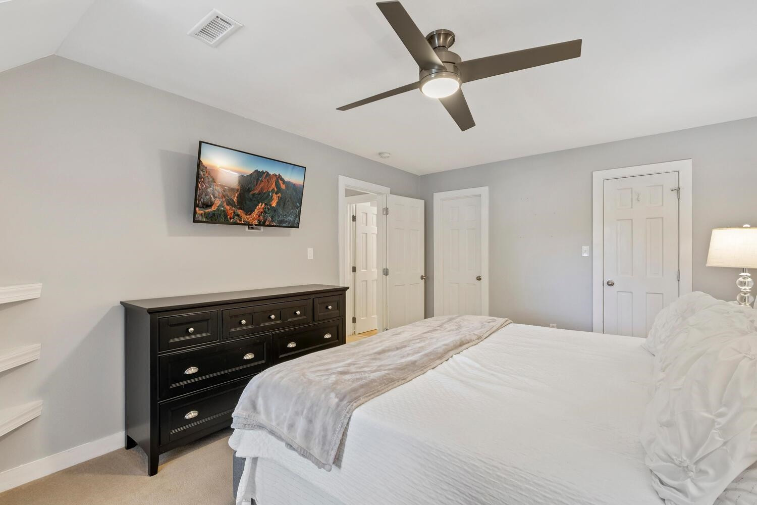 6600 Vancouver Lane Raleigh, NC 27615 - Photo 31 of 53 a bedroom with a bed and a flat tv screen on dresser