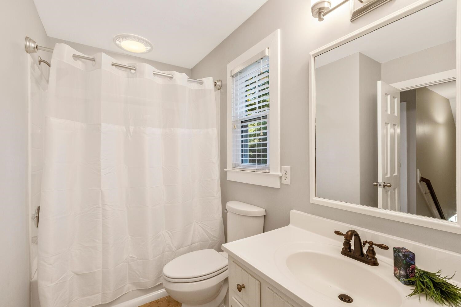 6600 Vancouver Lane Raleigh, NC 27615 - Photo 35 of 53 a bathroom with a sink a toilet and shower curtain