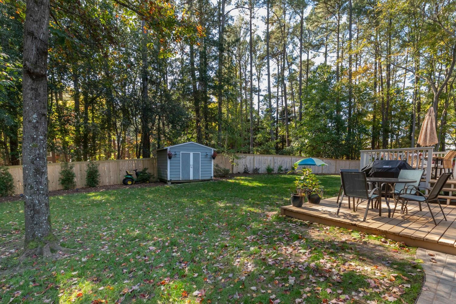 6600 Vancouver Lane Raleigh, NC 27615 - Photo 46 of 53 a backyard of a house with table and chairs