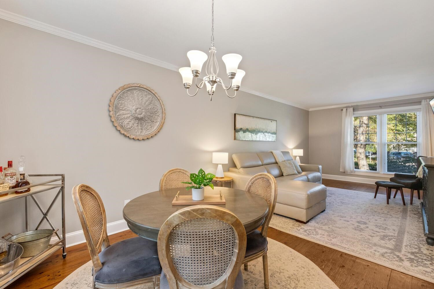 6600 Vancouver Lane Raleigh, NC 27615 - Photo 9 of 53 a view of a dining room with furniture a chandelier and wooden floor