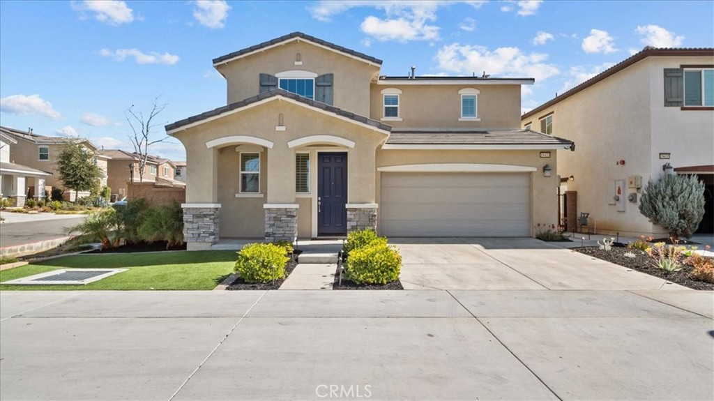 19433 Fortunello Avenue Riverside, CA 92508 - Photo 1 of 1 a front view of a house with garden