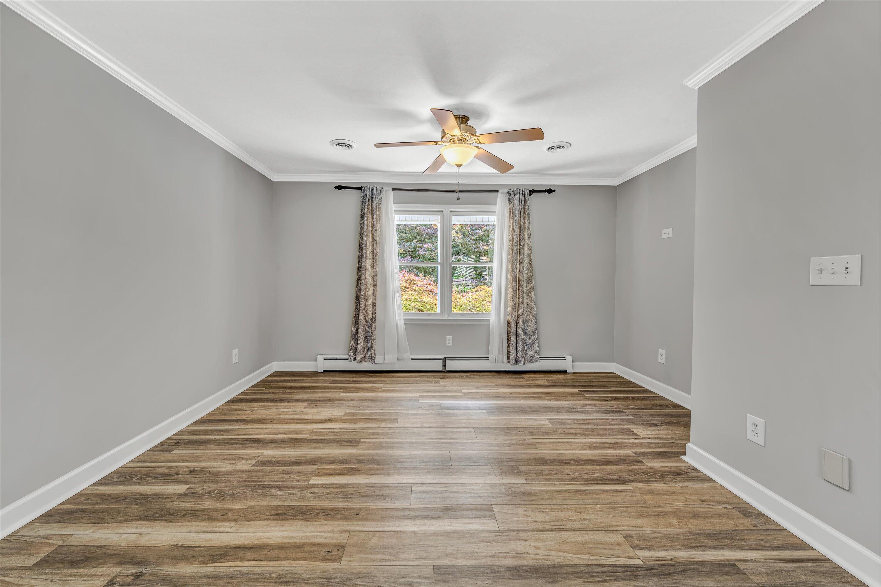 395 Middle Valley Road Hardy, VA 24101 - Photo 12 of 66 a view of an empty room with wooden floor and a window