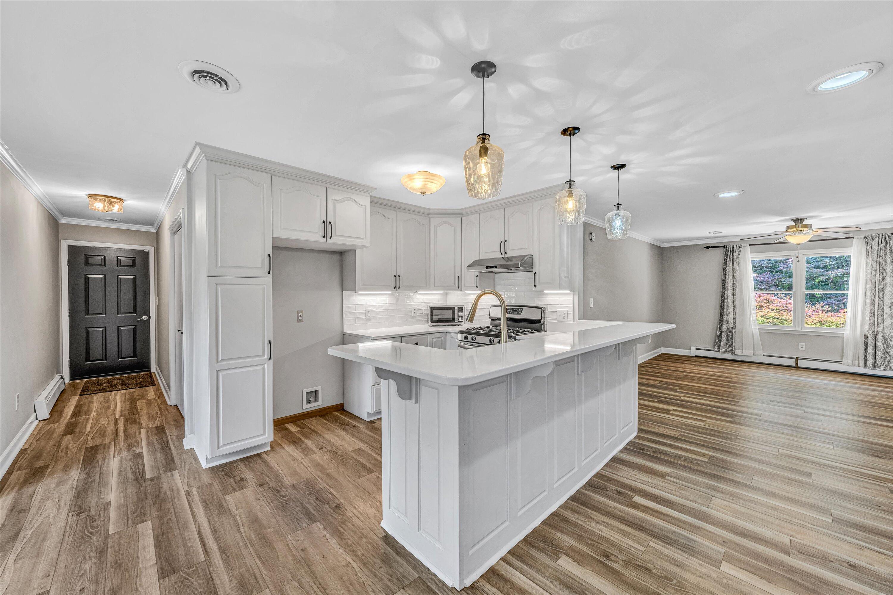 395 Middle Valley Road Hardy, VA 24101 - Photo 16 of 66 a large white kitchen with wooden floor