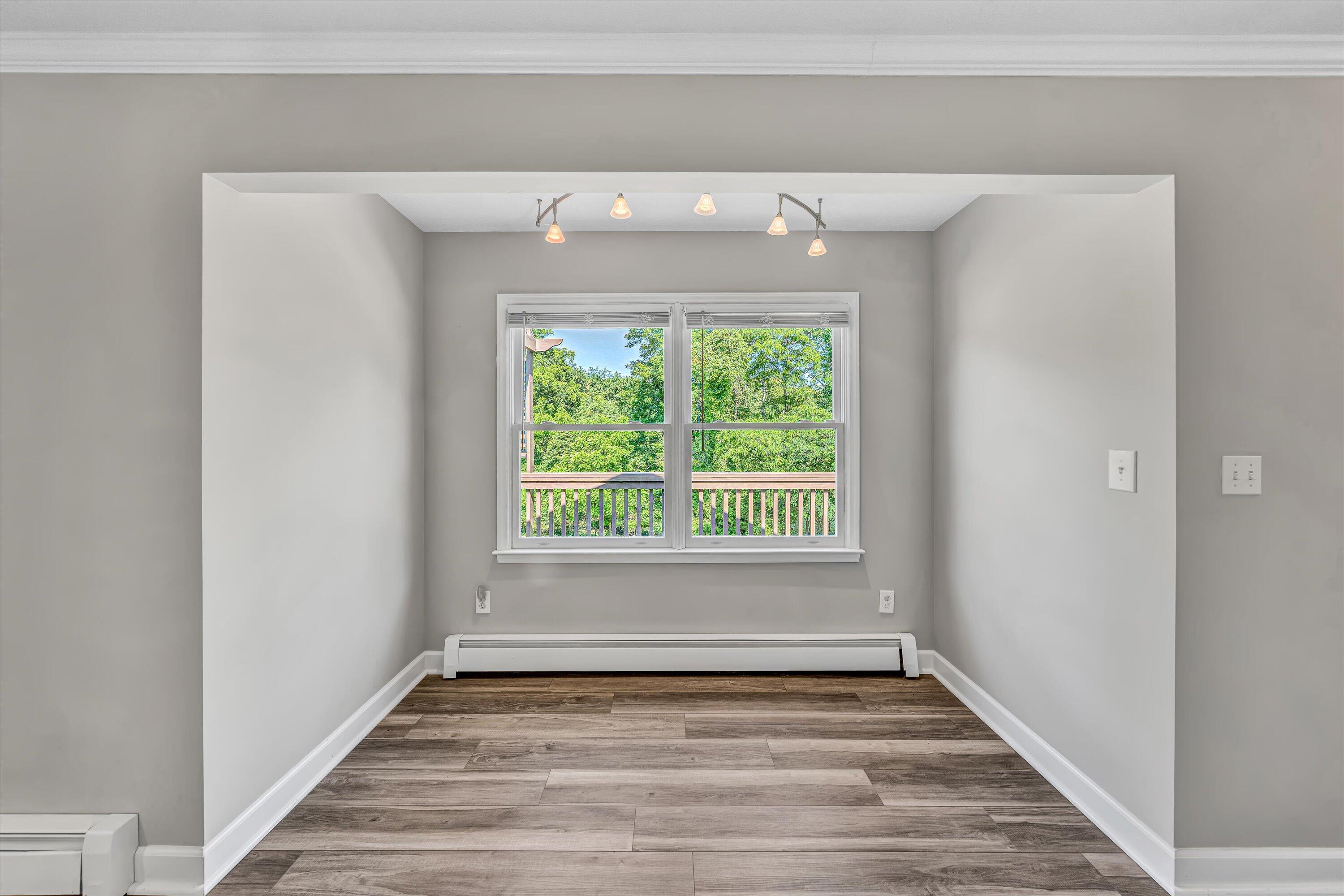 395 Middle Valley Road Hardy, VA 24101 - Photo 18 of 66 a view of an empty room with wooden floor and a window