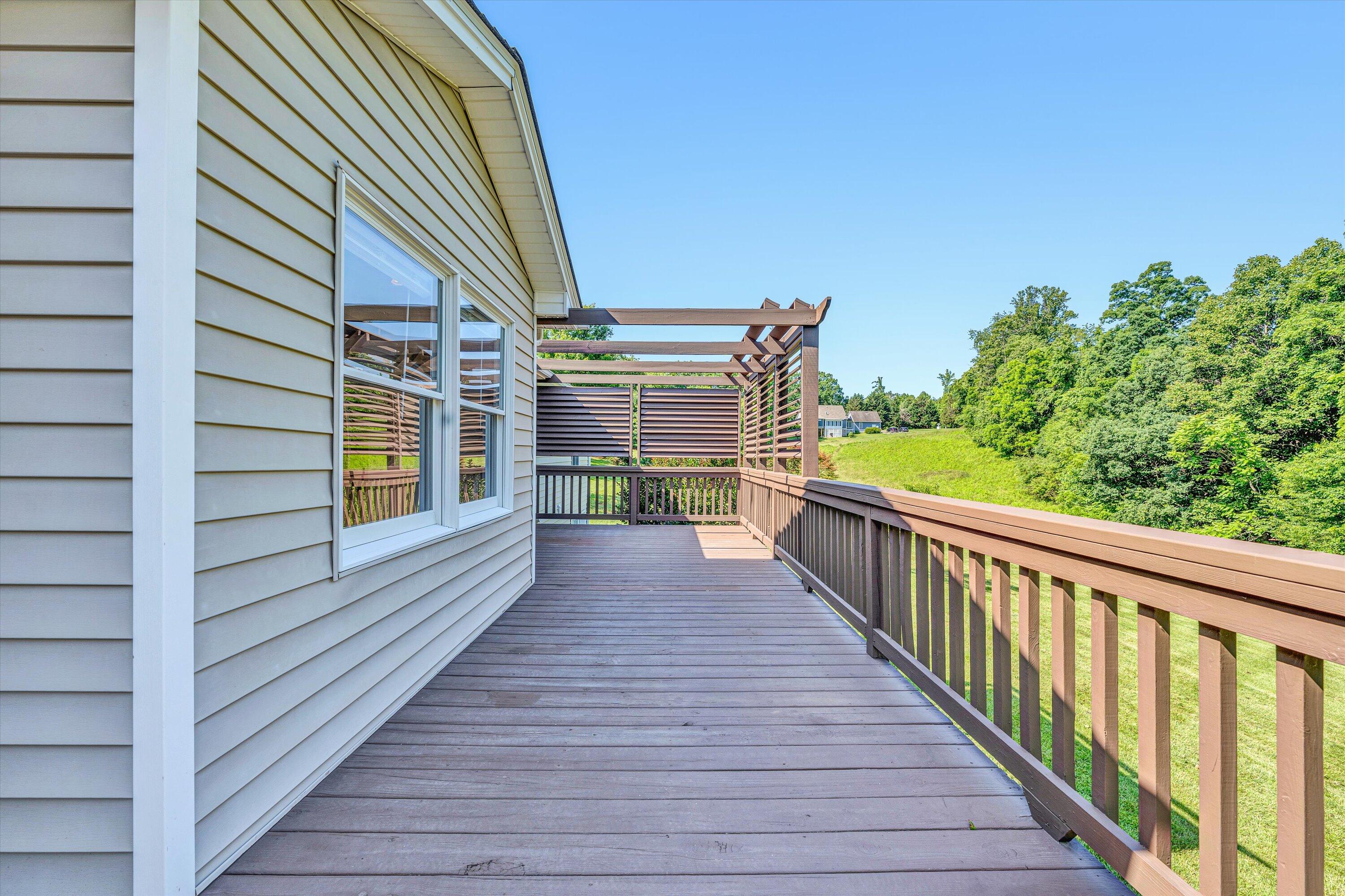 395 Middle Valley Road Hardy, VA 24101 - Photo 30 of 66 a view of a balcony with wooden floor and fence and a bench