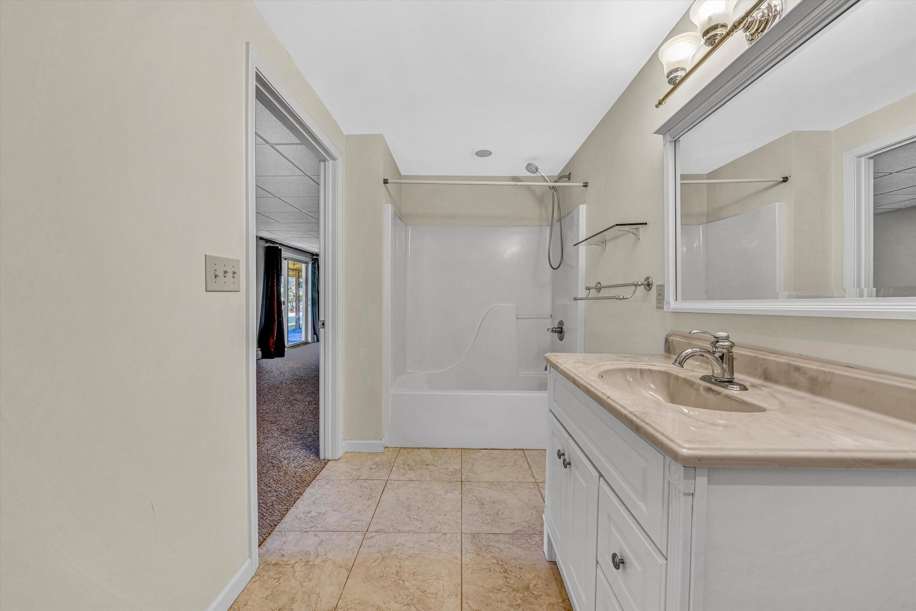 395 Middle Valley Road Hardy, VA 24101 - Photo 39 of 66 a bathroom with a sink a mirror and a bathtub