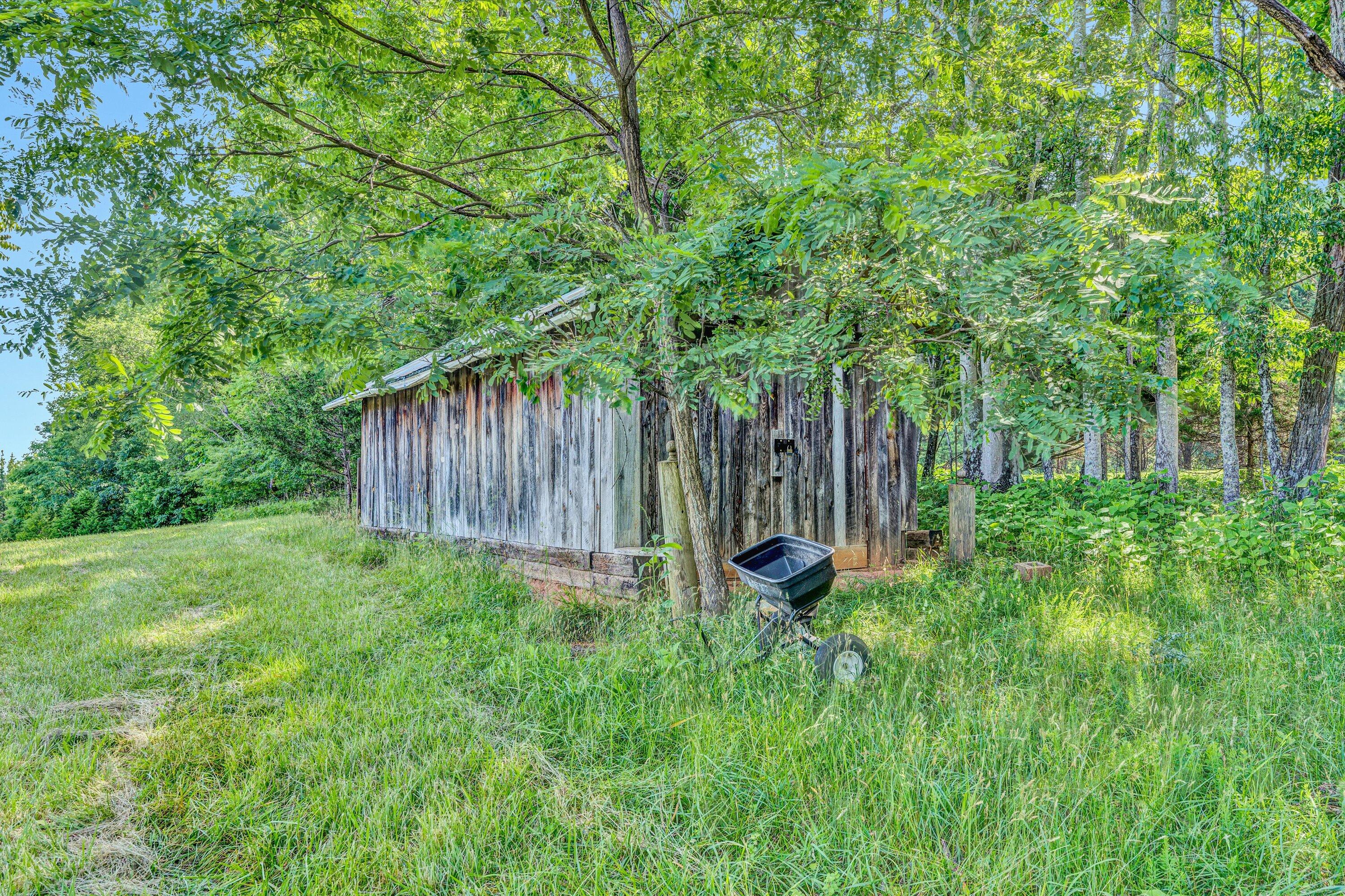 395 Middle Valley Road Hardy, VA 24101 - Photo 56 of 66 a view of backyard with large trees and wooden fence