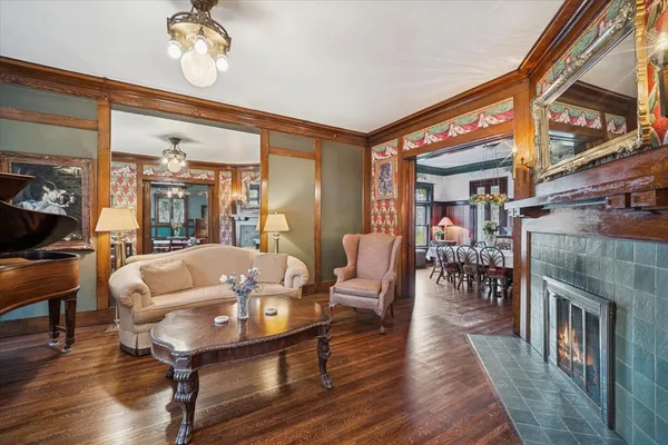 a living room with furniture a fireplace and a chandelier