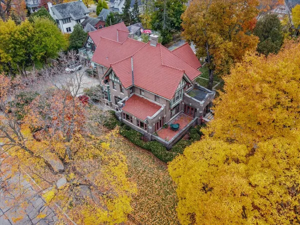 an aerial view of a house with a yard and trees