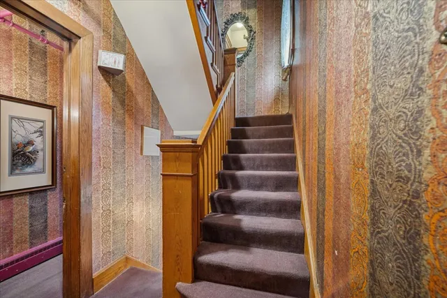 a bedroom with a bed a table and chair