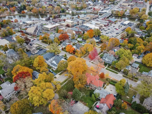 an aerial view of residential houses with yard