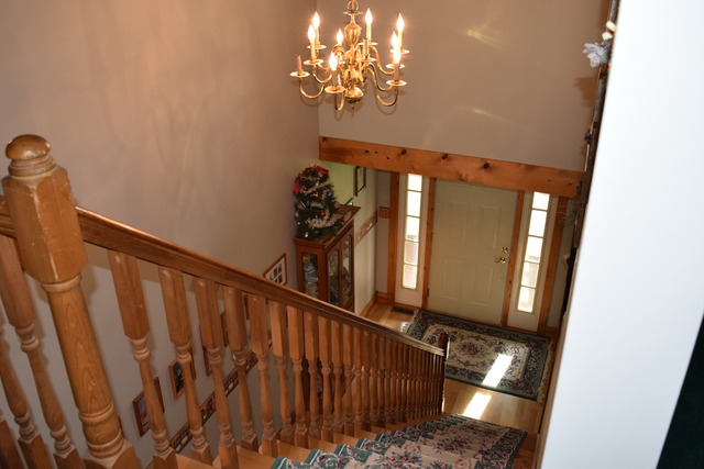 16152 University Road Malta, IL 60150 - Photo 11 of 24 a view of staircase with railing and a chandelier