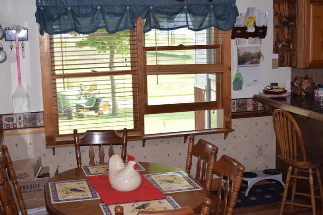 16152 University Road Malta, IL 60150 - Photo 5 of 24 a view of a dining room with furniture a chandelier and wooden floor