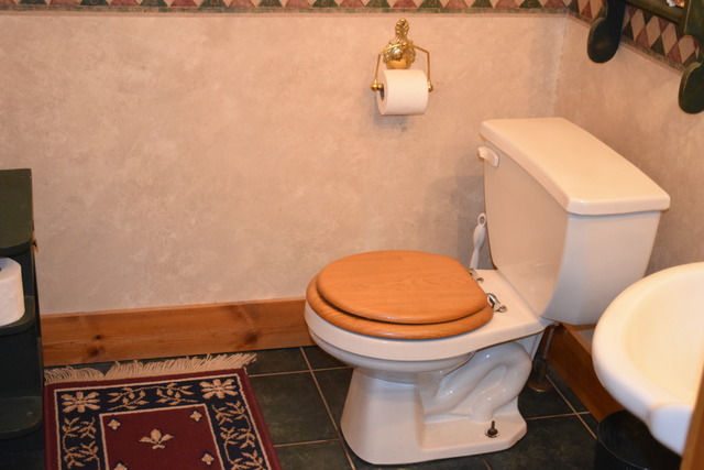 16152 University Road Malta, IL 60150 - Photo 8 of 24 a white toilet sitting next to a white wall