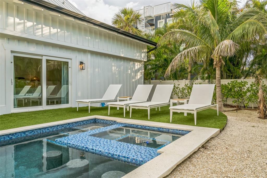 305 73rd Street Holmes Beach, FL 34217 - Photo 19 of 59 a view of an chairs and tables in the backyard