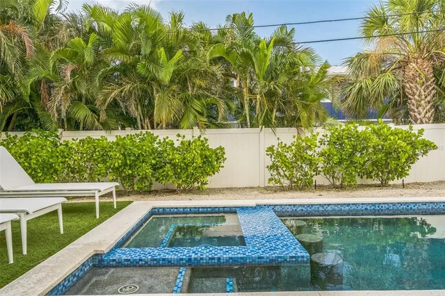a view of a backyard with swimming pool