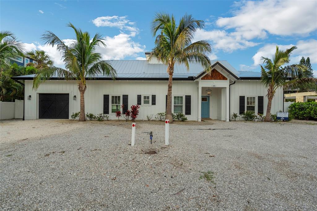 305 73rd Street Holmes Beach, FL 34217 - Photo 23 of 59 a view of a house with a patio and a yard